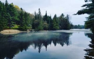 Morning mist on the beautiful Muskoka River with trees reflecting in the water as seen from your private beach at Muskoka Waterfront Cottage Retreat Morning mist on the beautiful Muskoka River with trees reflecting in the water as seen from your private beach at Muskoka Waterfront Cottage Retreat